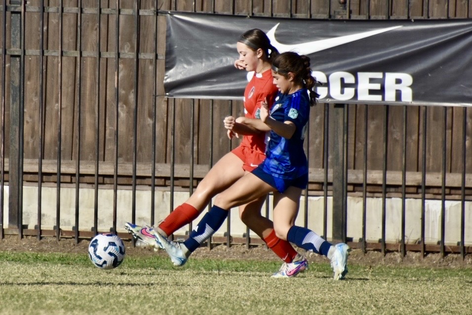 Olivia Leddy playing soccer against another team