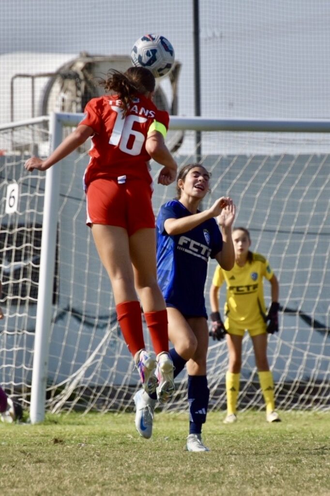 Olivia Leddy heading the soccer ball