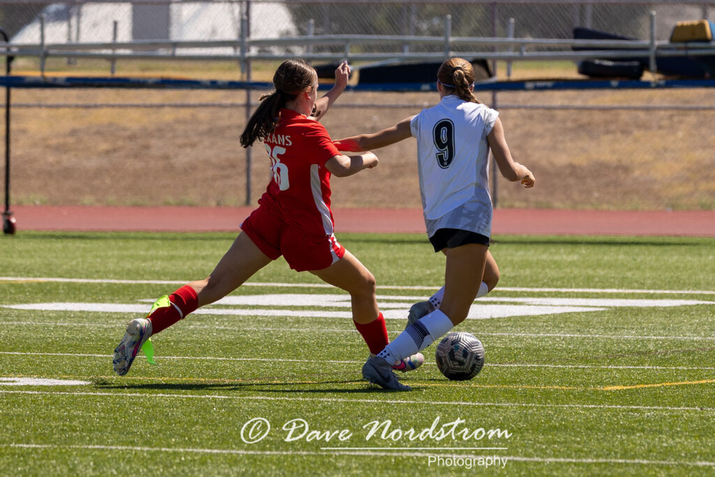 Olivia Leddy playing soccer against another team